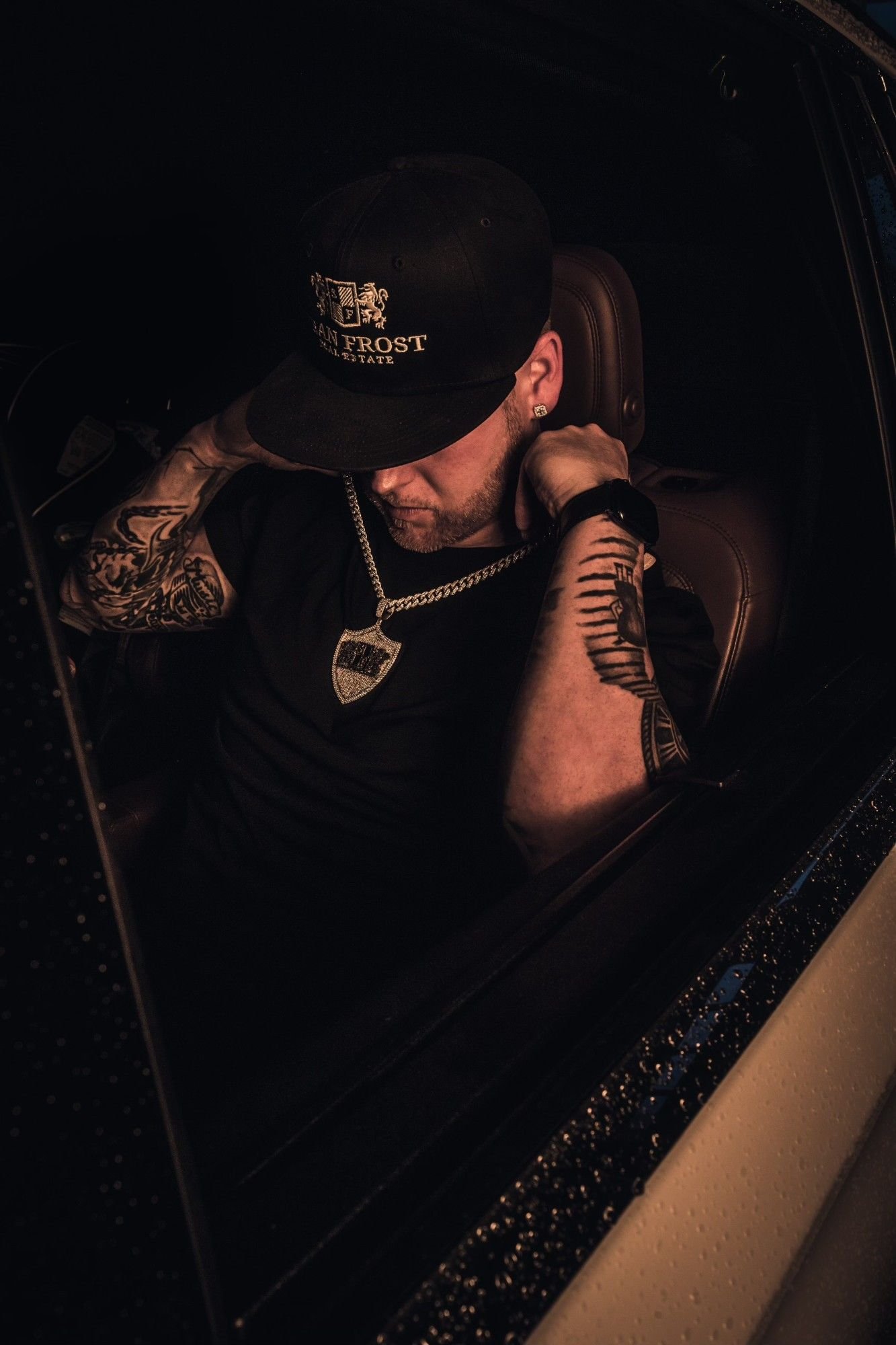 Sean Frost looking down from the driver’s seat in a Sean Frost cap