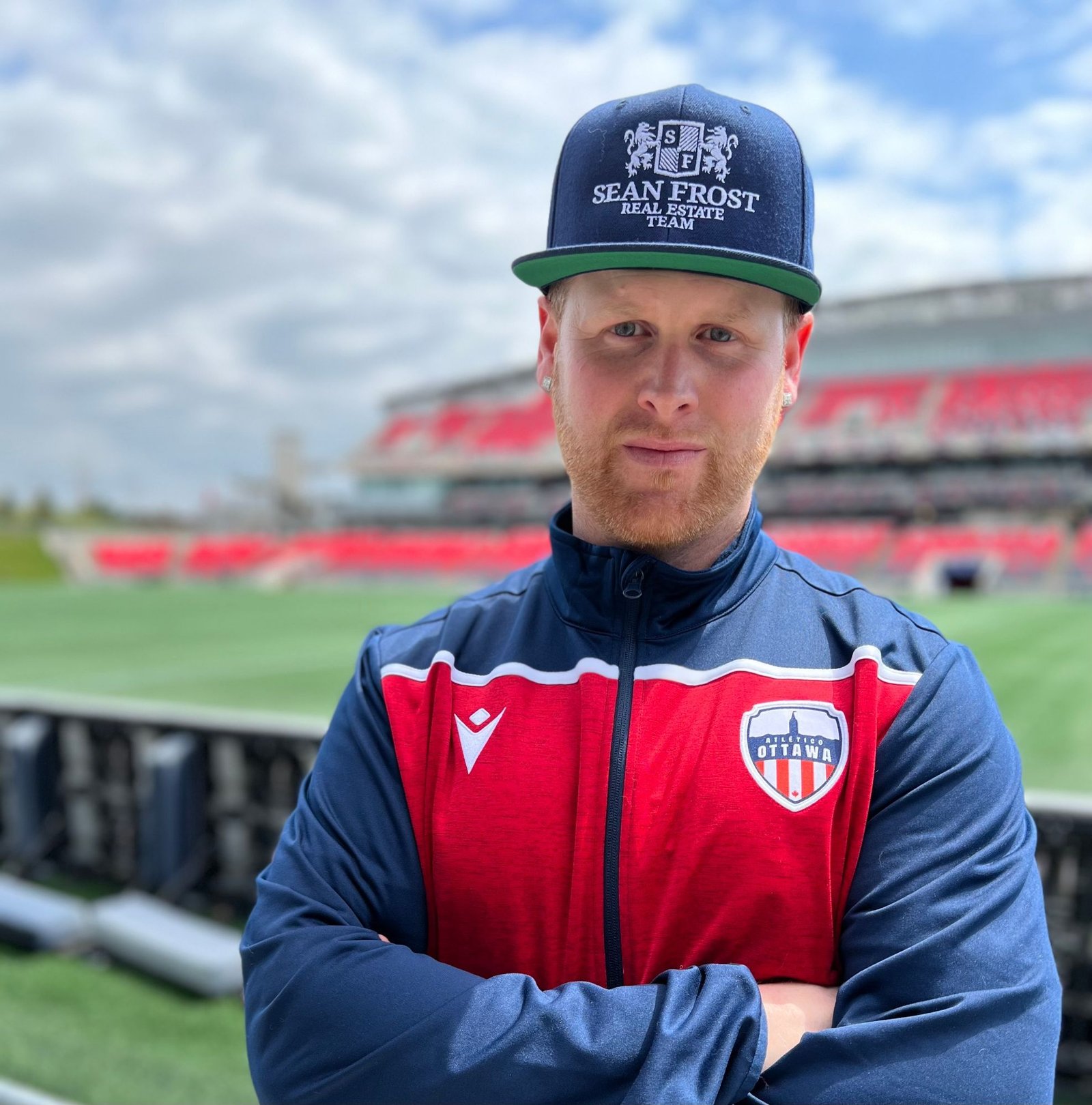 Sean Frost in an Atlético Ottawa track jacket at the stadium